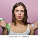 pretty-woman-holding-bottle-skin-260nw-495372811